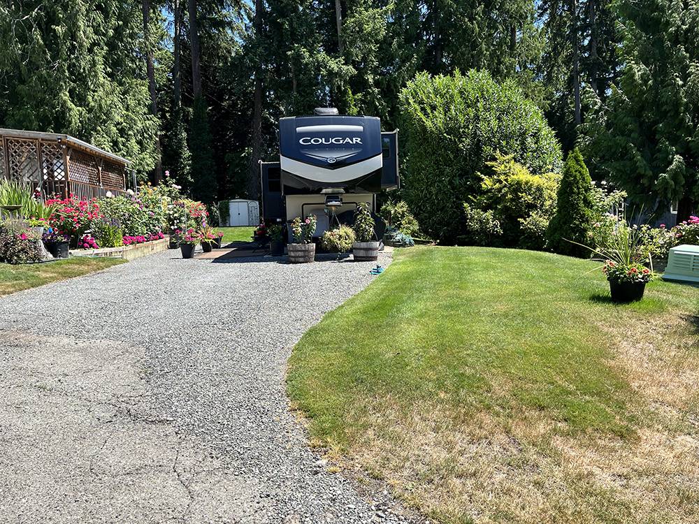 An RV in a gravel site with landscaping