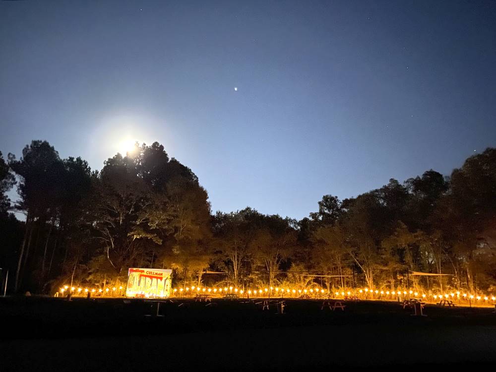 The cornhole area at night