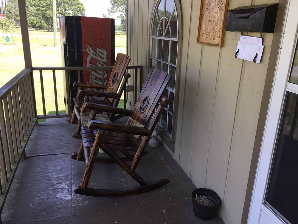 Porch with rocking chairs near front door of office at WEEKS ISLAND RV PARK