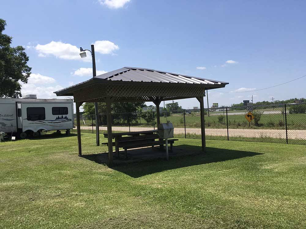 Shaded area with picnic table at WEEKS ISLAND RV PARK