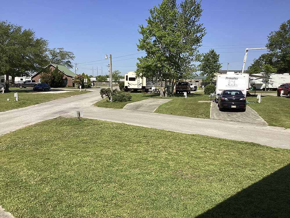 Paved RV sites with grass at CAMPGROUNDS OF THE SOUTH