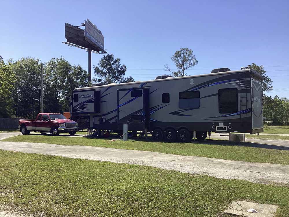 A fifth wheel trailer in an RV site at CAMPGROUNDS OF THE SOUTH