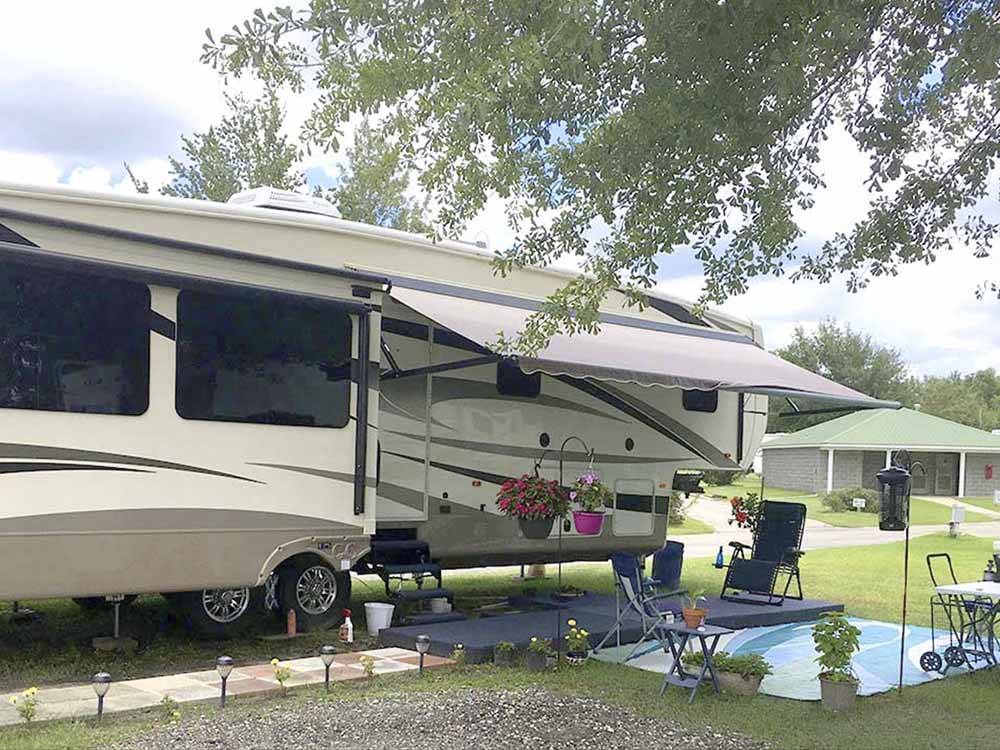 A fifth wheel trailer with its awning out at CAMPGROUNDS OF THE SOUTH