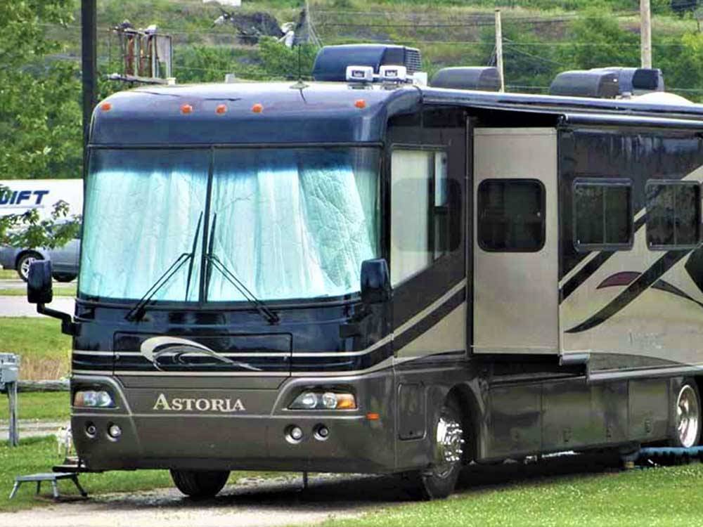 A motorhome in a gravel site at WESTGATE RV CAMPGROUND