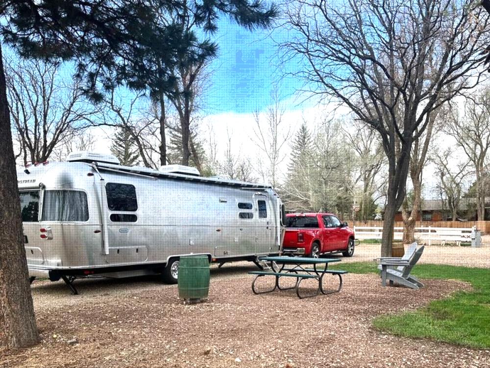 Parked trailer with red pickup truck at site La Veta Pines RV Park
