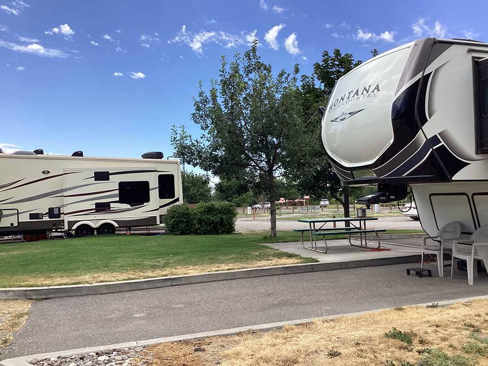 Fifth-wheel parked in paved campsite with picnic table at HEYBURN RIVERSIDE RV PARK
