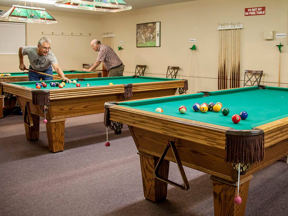 Men playing pool at ENCORE CACTUS GARDENS