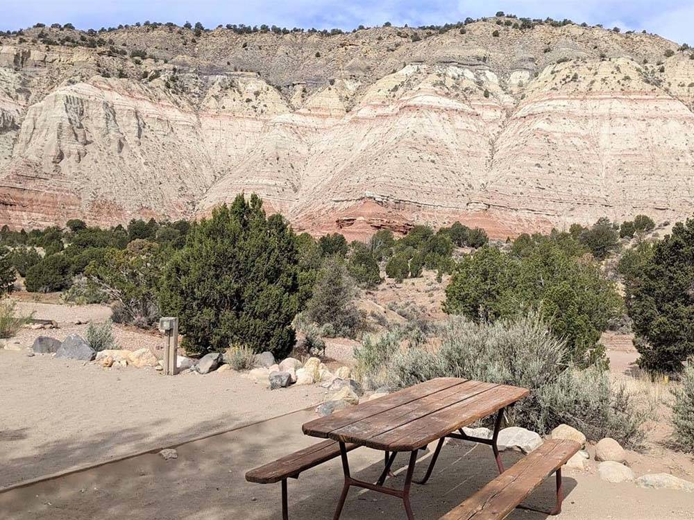 A dirt RV site with a picnic bench at BRYCE CANYON RV RESORT BY RJOURNEY