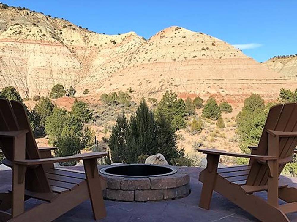 Two lounge chairs and fire pit at BRYCE CANYON RV RESORT BY RJOURNEY