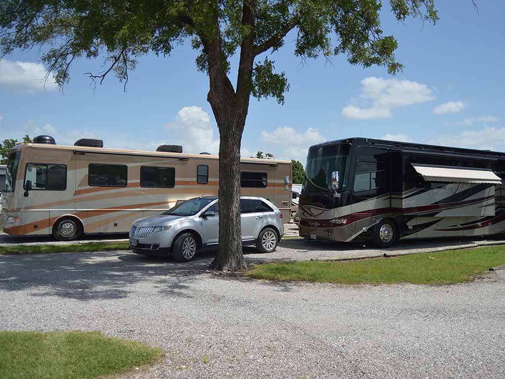 A couple of motorhomes in pull thru sites at LAZY L RV PARK