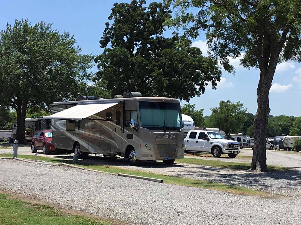 A motorhome in a gravel RV site at LAZY L RV PARK