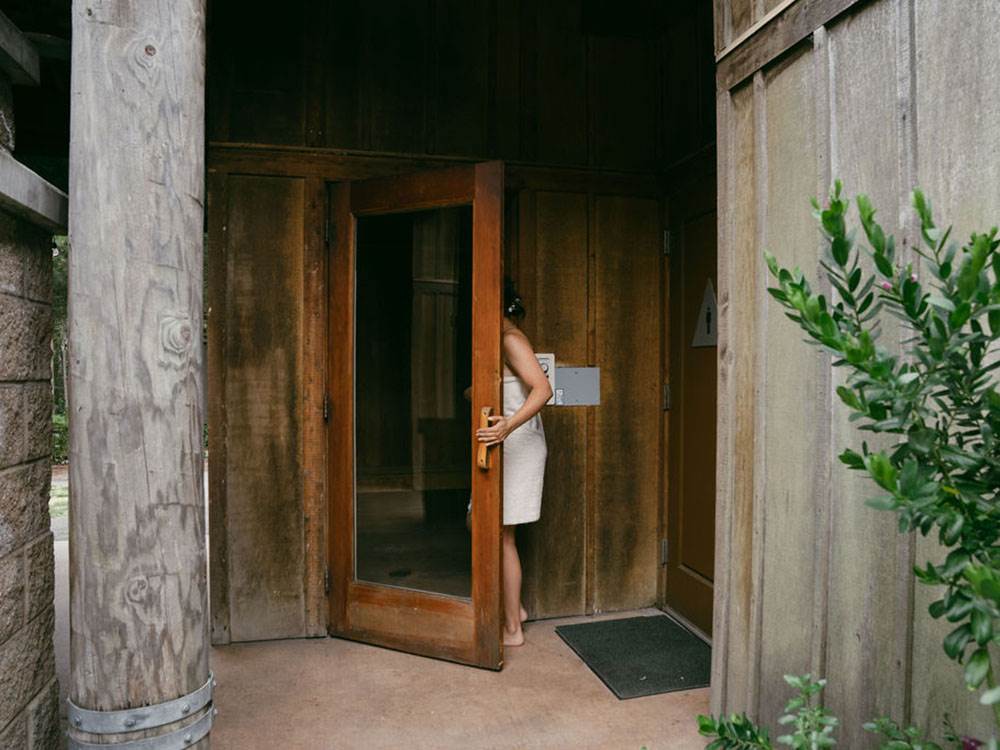 A woman walking into a sauna