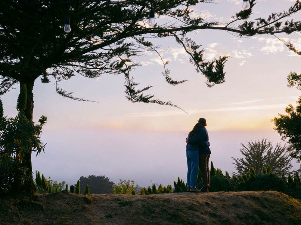 A couple hugging watching the sunset