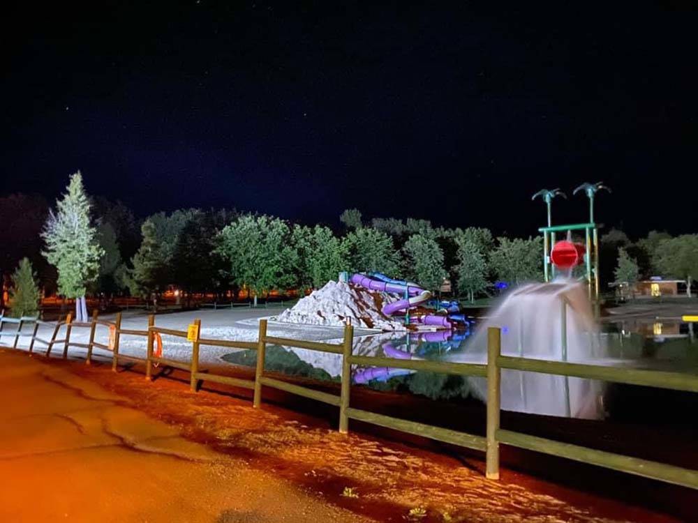 The water park at night frozen with snow at CAMPING PARADIS DE LA P'TITE MONTAGNE