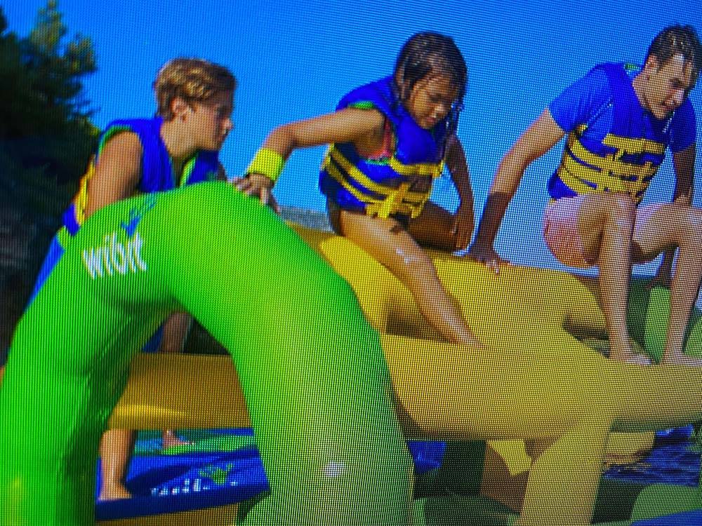 Kids climbing the Wibit floats at CAMPING PARADIS DE LA P'TITE MONTAGNE