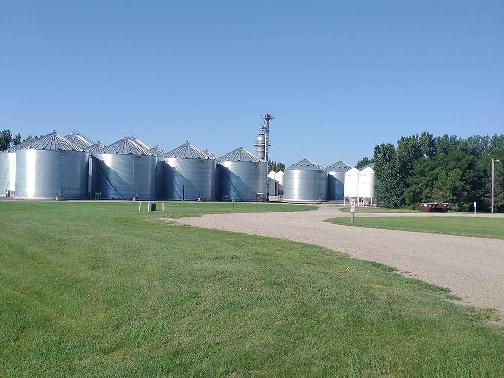 Gravel road leading to silos at A PRAIRIE BREEZE RV PARK