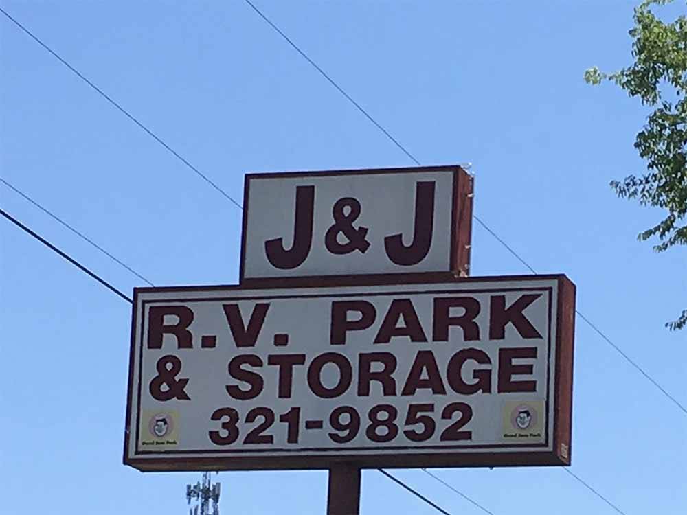 Park sign with power lines running behind it at J & J RV PARK