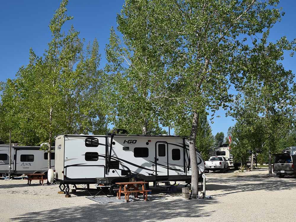 Travel trailer at gravel campsite at ARROWHEAD RV PARK