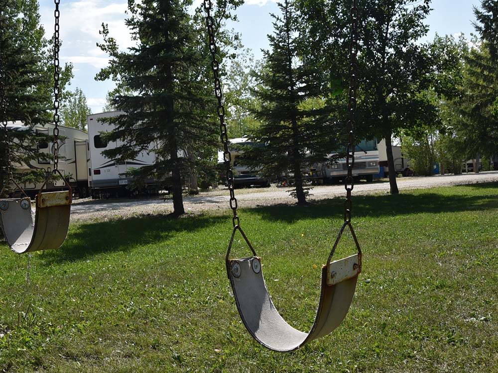 Swing set with RVs in the background at ARROWHEAD RV PARK