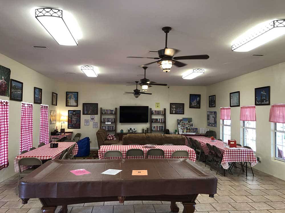 Hall with long dining tables and pool table at LAKE CITY RV RESORT