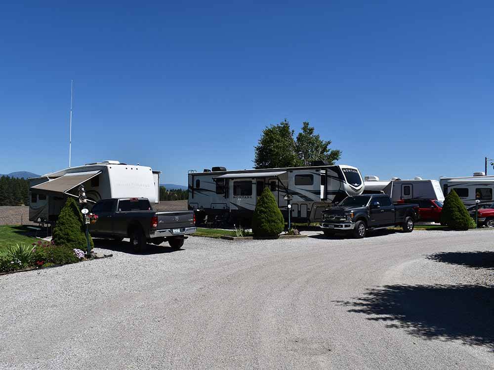 A gravel road in front of back in RV sites at WILD ROSE RV PARK