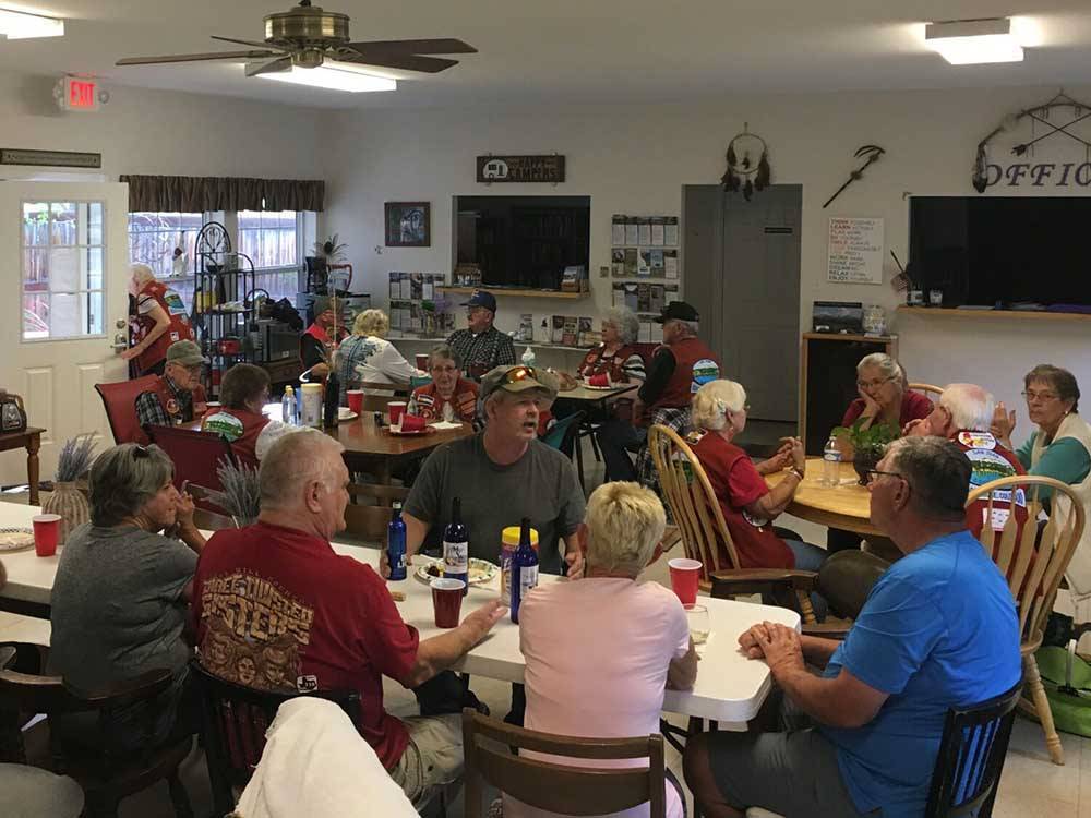 Group of people gathered in the community room at UNCOMPAHGRE RIVER ADULT RV PARK