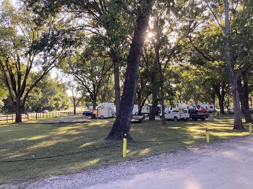 Two trucks and a trailer parked on the grass at PARK RIDGE RV CAMPGROUND