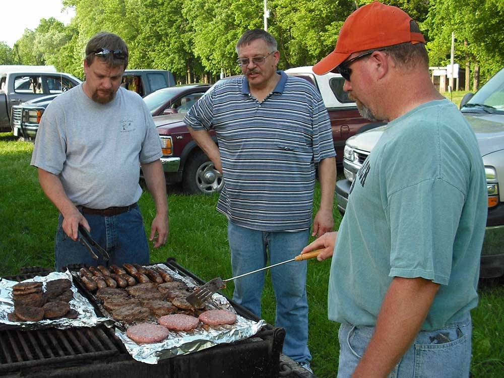 Men grilling quality meats at BSC OUTDOORS CAMPING & FLOAT TRIPS