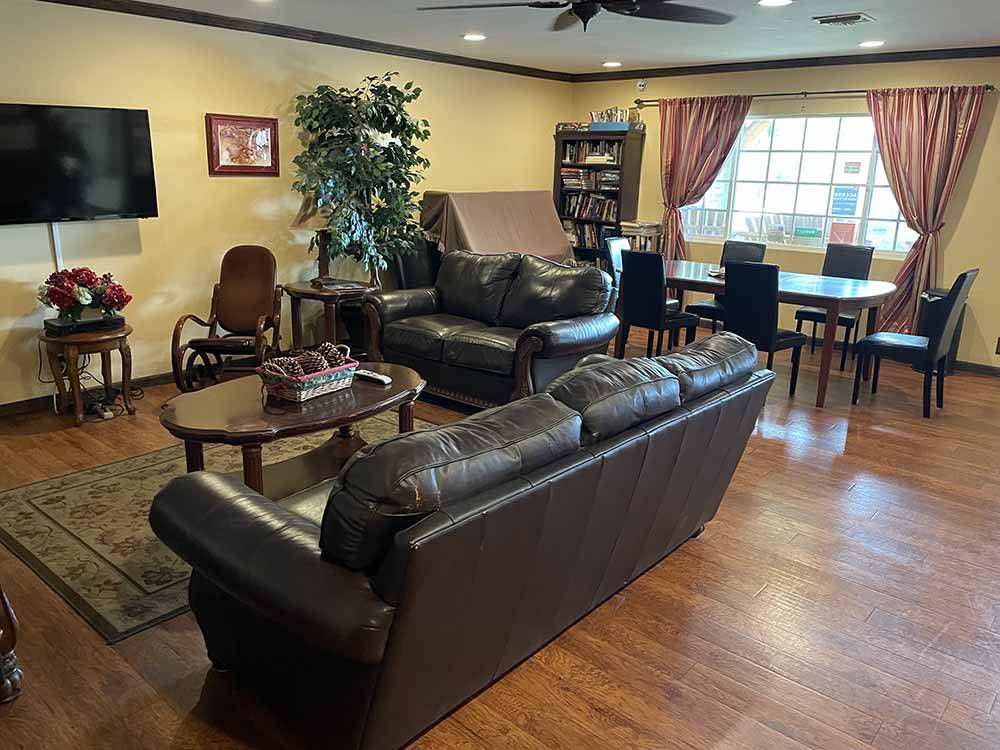 A leather couch and love seat in the main hall at AUBURN GOLD COUNTRY RV PARK