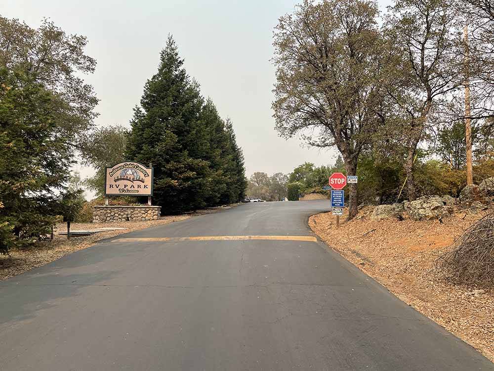 The paved front entrance road and sign at AUBURN GOLD COUNTRY RV PARK