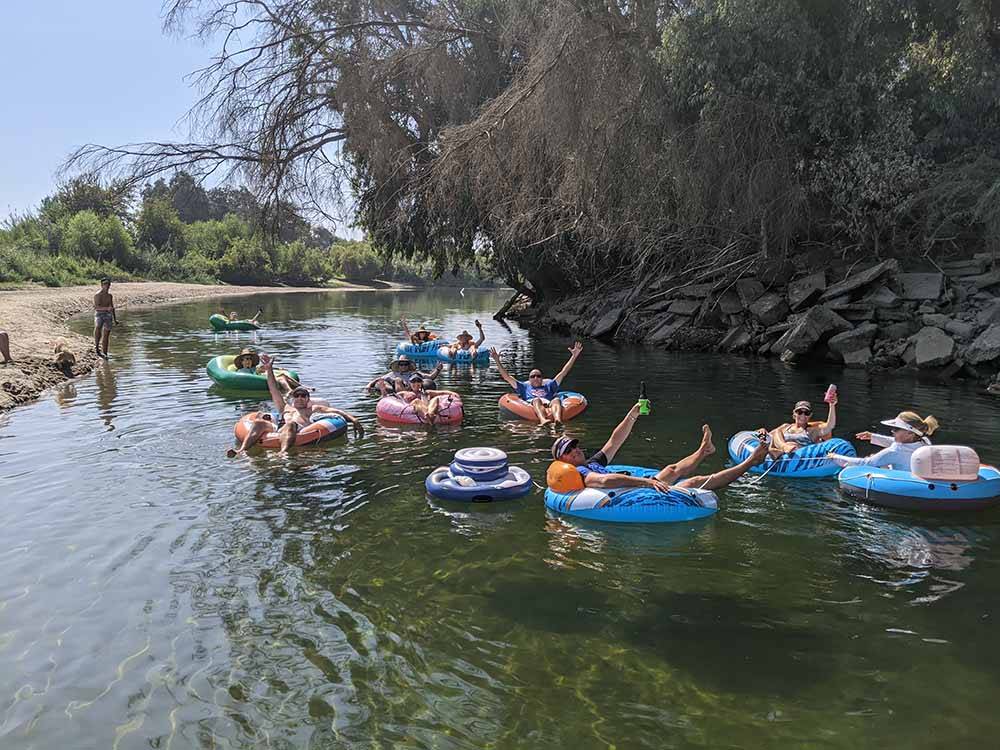 People floating down the river on inner tubes at KINGS RIVER RV RESORT