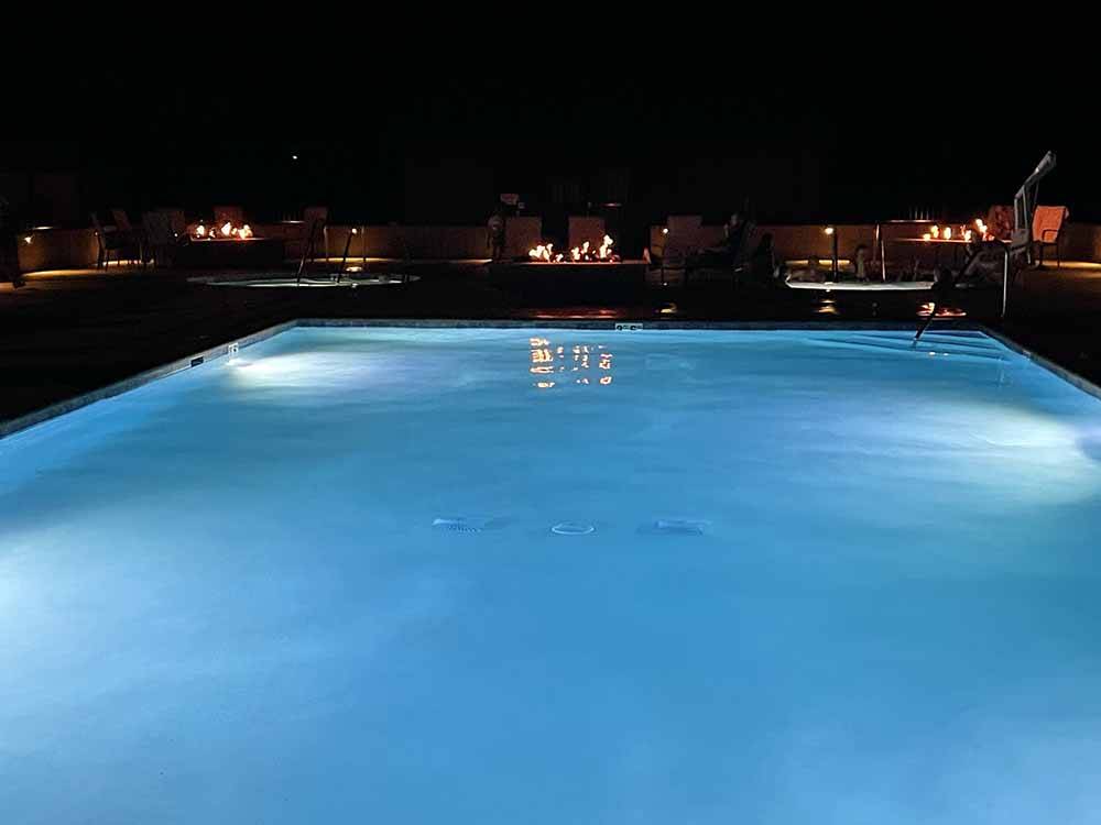 The swimming pool lit up at night at KINGS RIVER RV RESORT