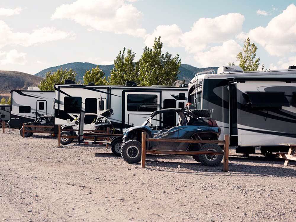 ATVs and travel trailers parked in sites at SOUTH FORTY RV PARK