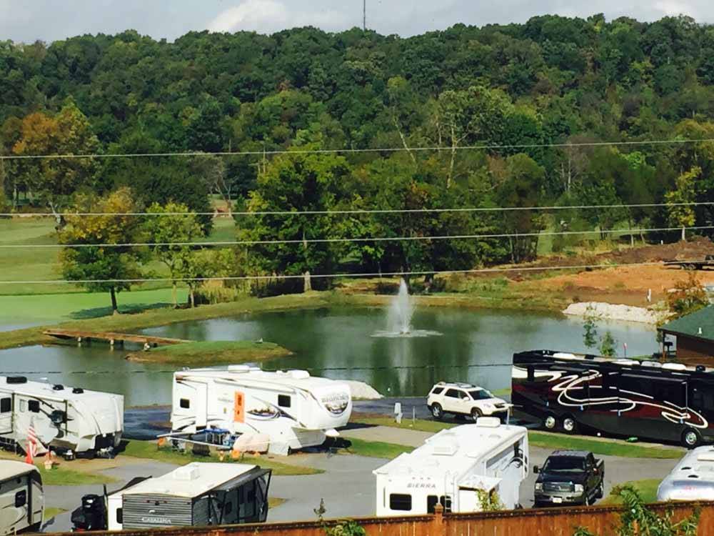 RVs camping near pond with fountain at THE CREEKS GOLF & RV RESORT