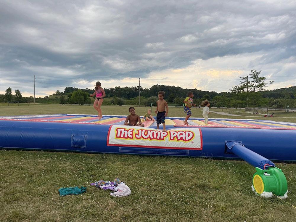 Kids playing on the jump pad at ASHLAND/HUNTINGTON WEST KOA HOLIDAY