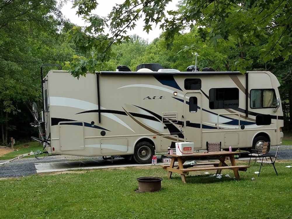 A picnic table next to a motorhome at RIFRAFTERS CAMPGROUND