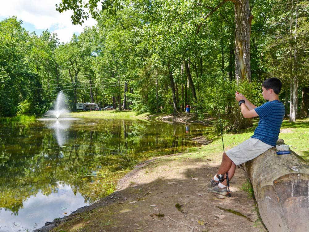 Boy fishing on lake at THOUSAND TRAILS RONDOUT VALLEY