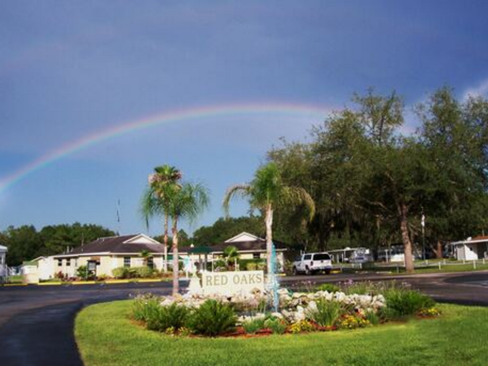 Rainbow by sign at Red Oaks Sun RV Communities