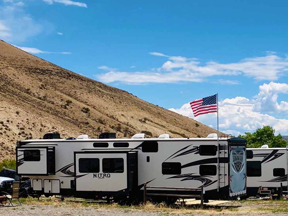 A Nitro travel trailer with a USA flag at THOUSAND TRAILS BLUE MESA RECREATIONAL RANCH