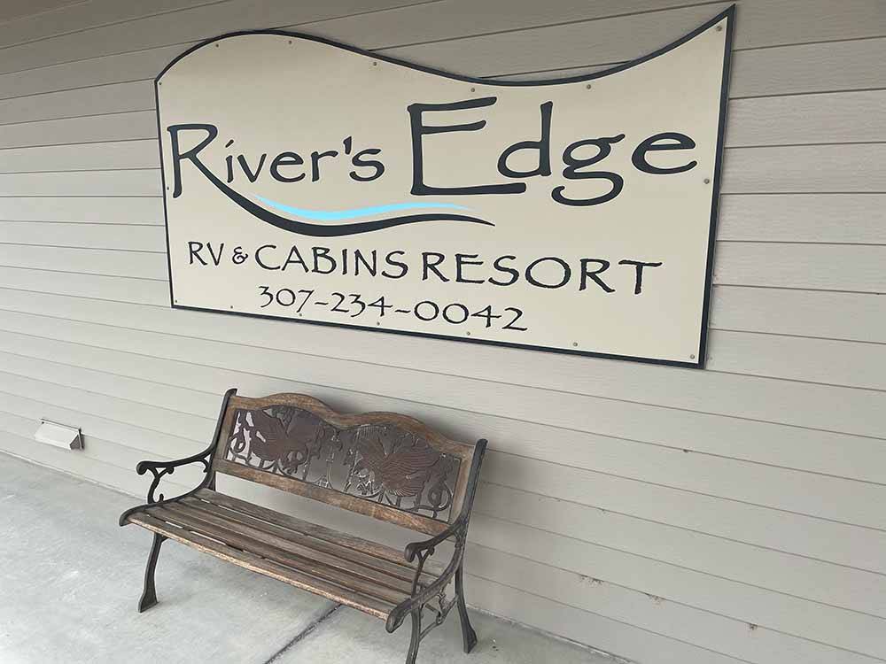 A park bench in front of the office at RIVER'S EDGE RV RESORT