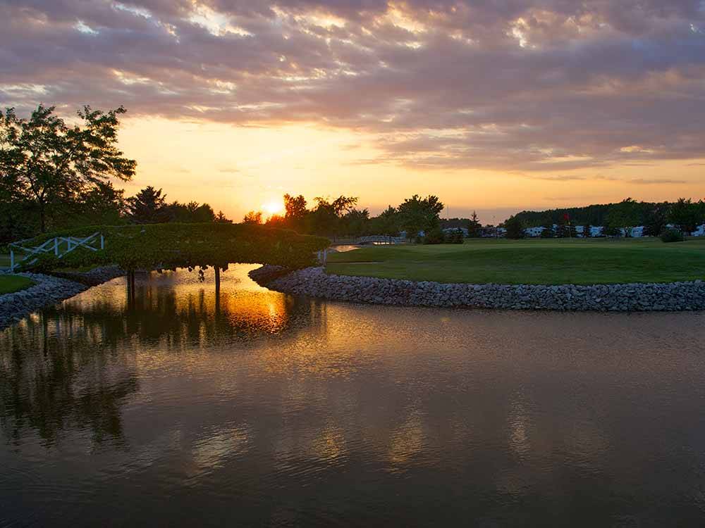 View of the river with a walking bridge at WILDWOOD GOLF  RV RESORT