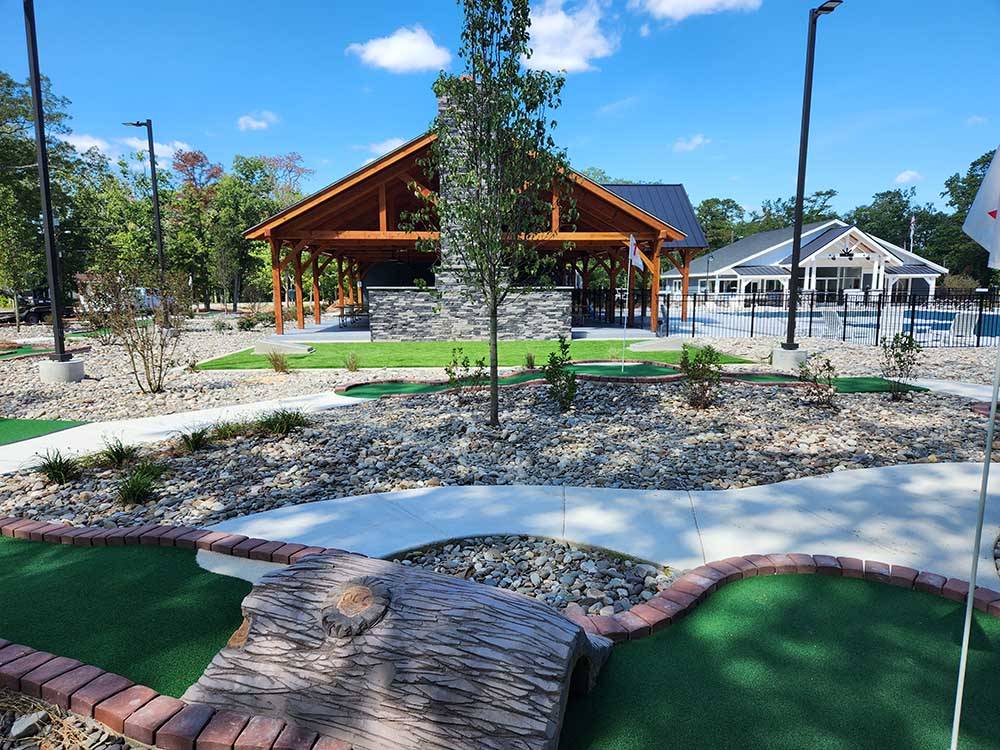 Miniature golf course with pool/pavilion in distance at OCEAN CITY CAMPGROUND AND BEACH CABINS