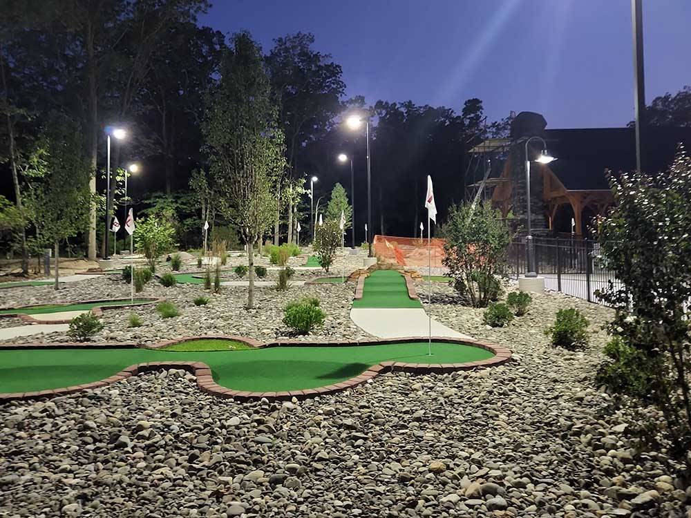 Miniature golf course lit up at night at OCEAN CITY CAMPGROUND AND BEACH CABINS