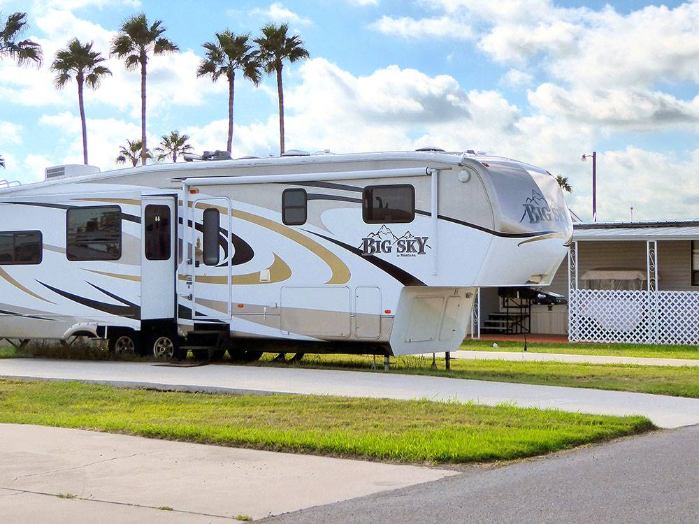 A fifth wheel trailer in a site at SNOW TO SUN RV RESORT