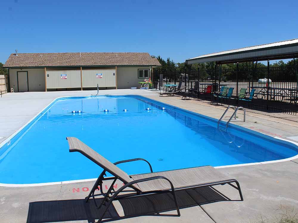 A lounge chair next to the swimming pool at SPRING LAKE RV RESORT