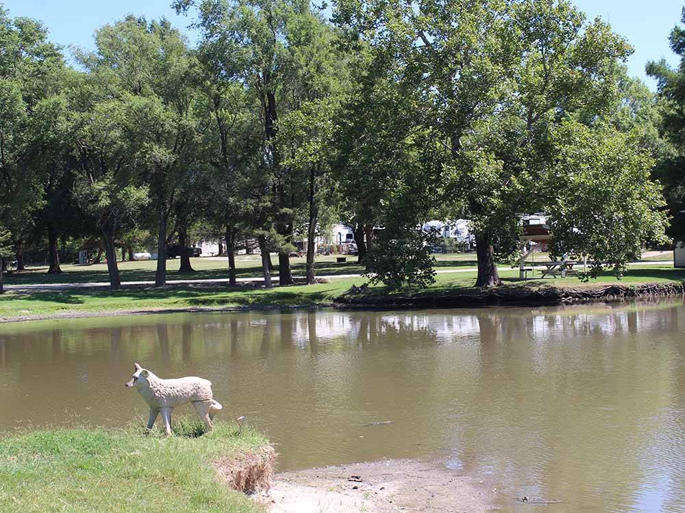 A statue of an animal next to the lake at SPRING LAKE RV RESORT