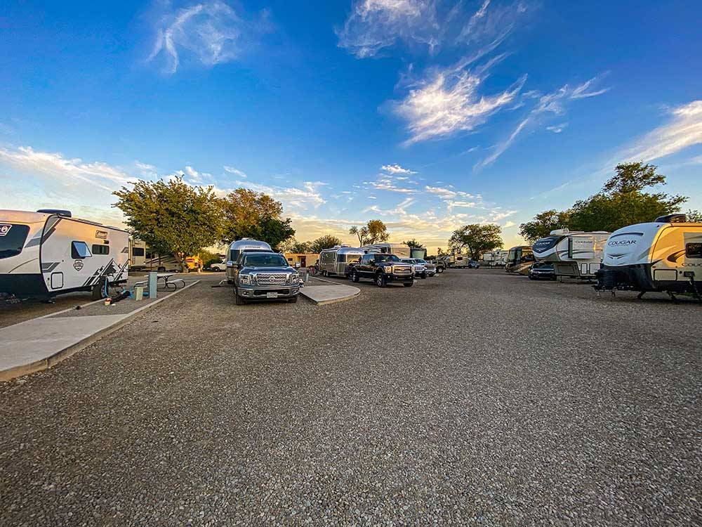 Rows of trailers and motorhomes parked in gravel sites at TRAILER VILLAGE RV PARK