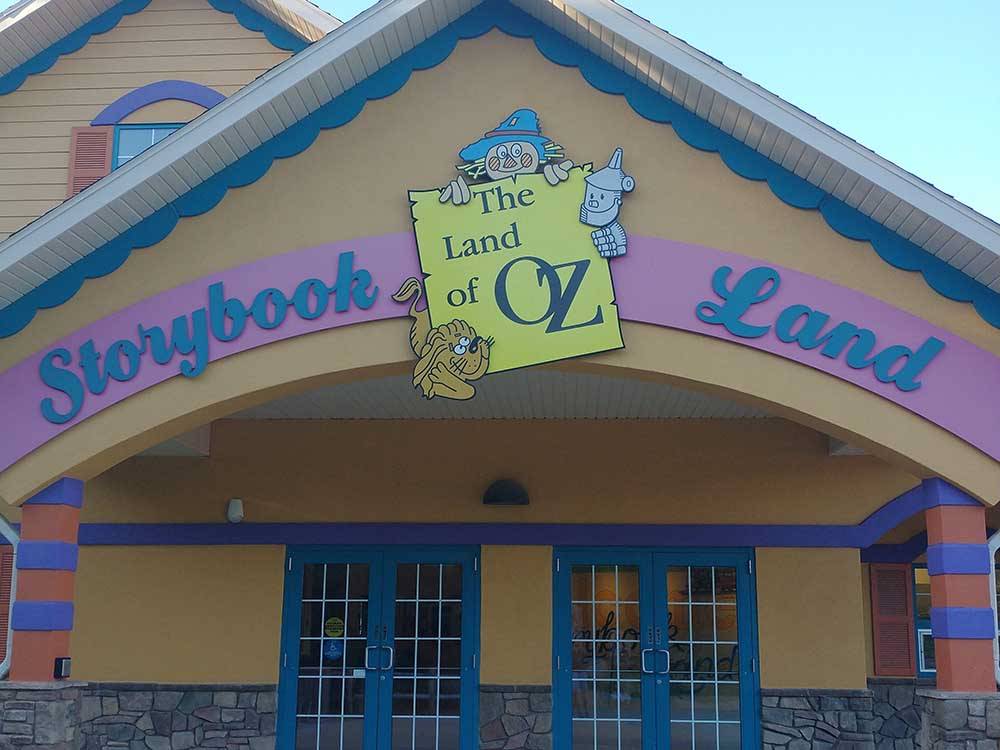 A building with a sign that proclaims it is Storybook Land at WYLIE PARK CAMPGROUND & STORYBOOK LAND