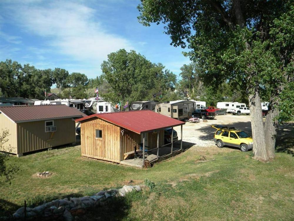 RVs parked on gravel sites and small buildings at Powder River Campground