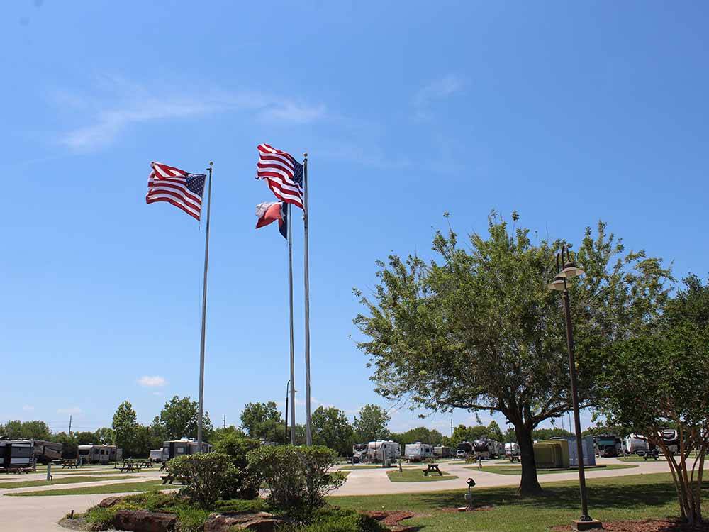 Three flags at the entrance at GULF COAST RV RESORT